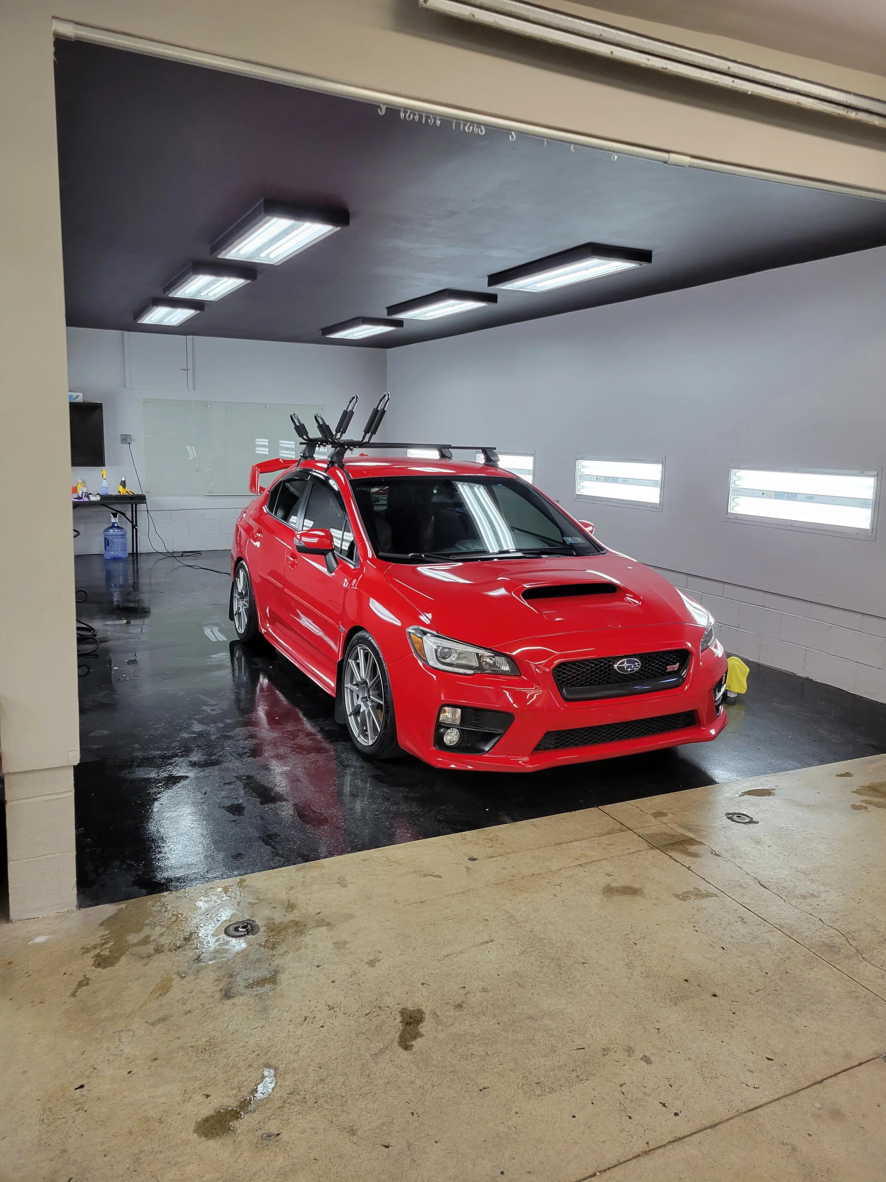 Red Subaru WRX STI in professional detail bay — GNelson Detailing